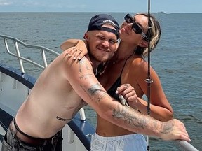 Zach Bryan and girlfriend Samantha Leonard fishing on a boat.