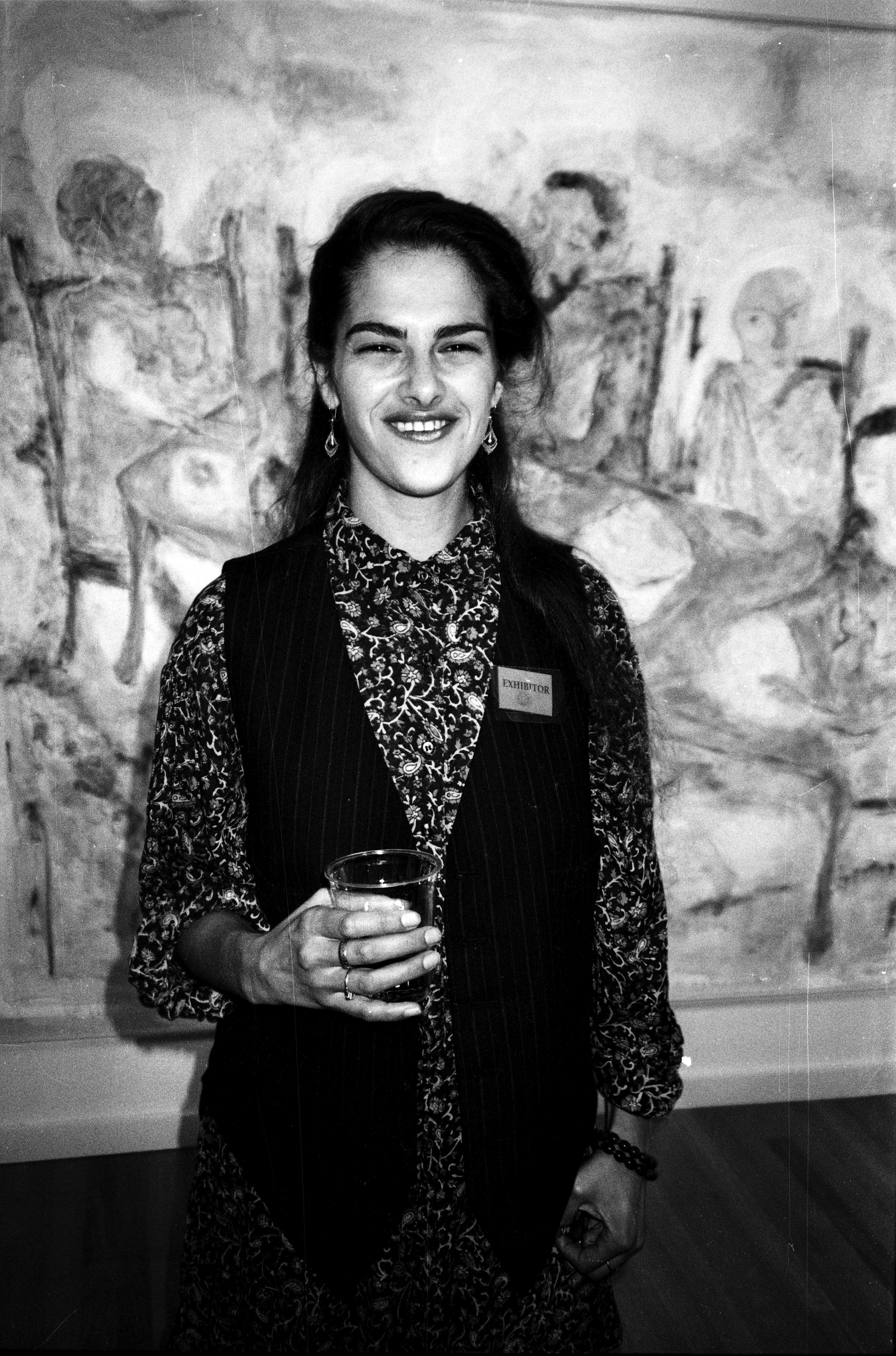 Tracey Emin at her graduation show at the Royal College of Art, with one of her paintings in the background.