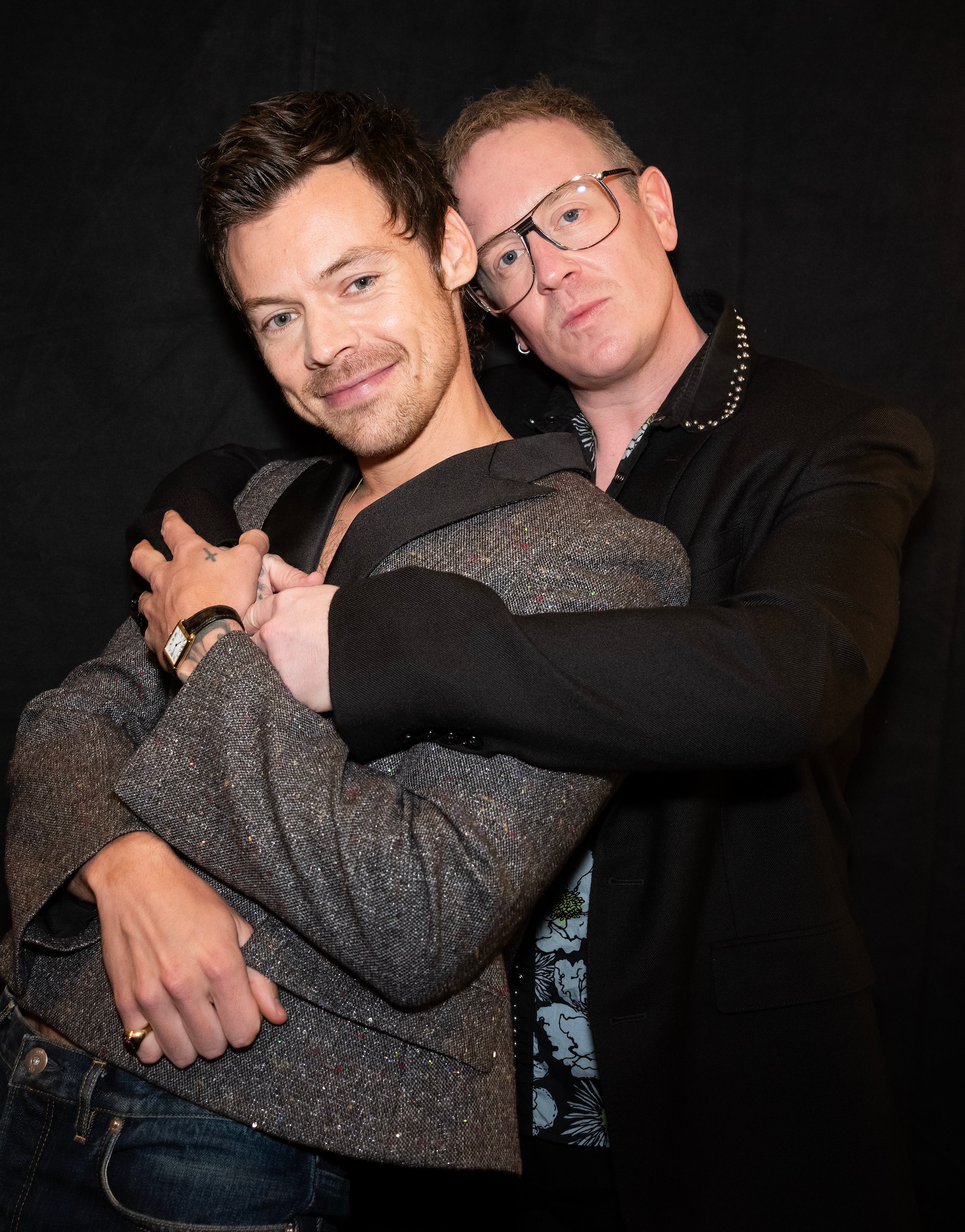 Harry Styles is embraced by writer and director Michael Grandage.
