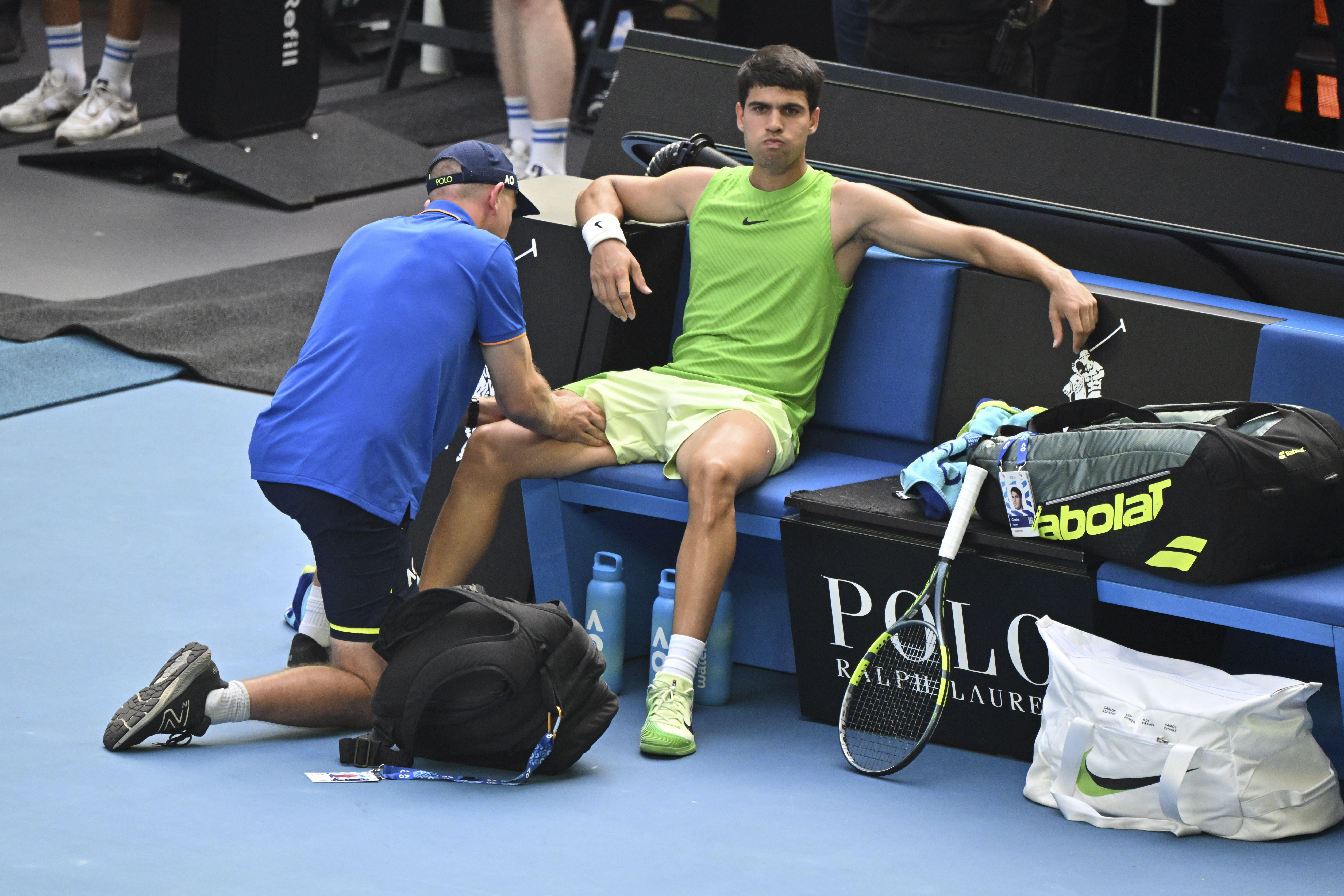 Carlos Alcaraz receiving treatment during a tennis match at the Australian Open 2026.