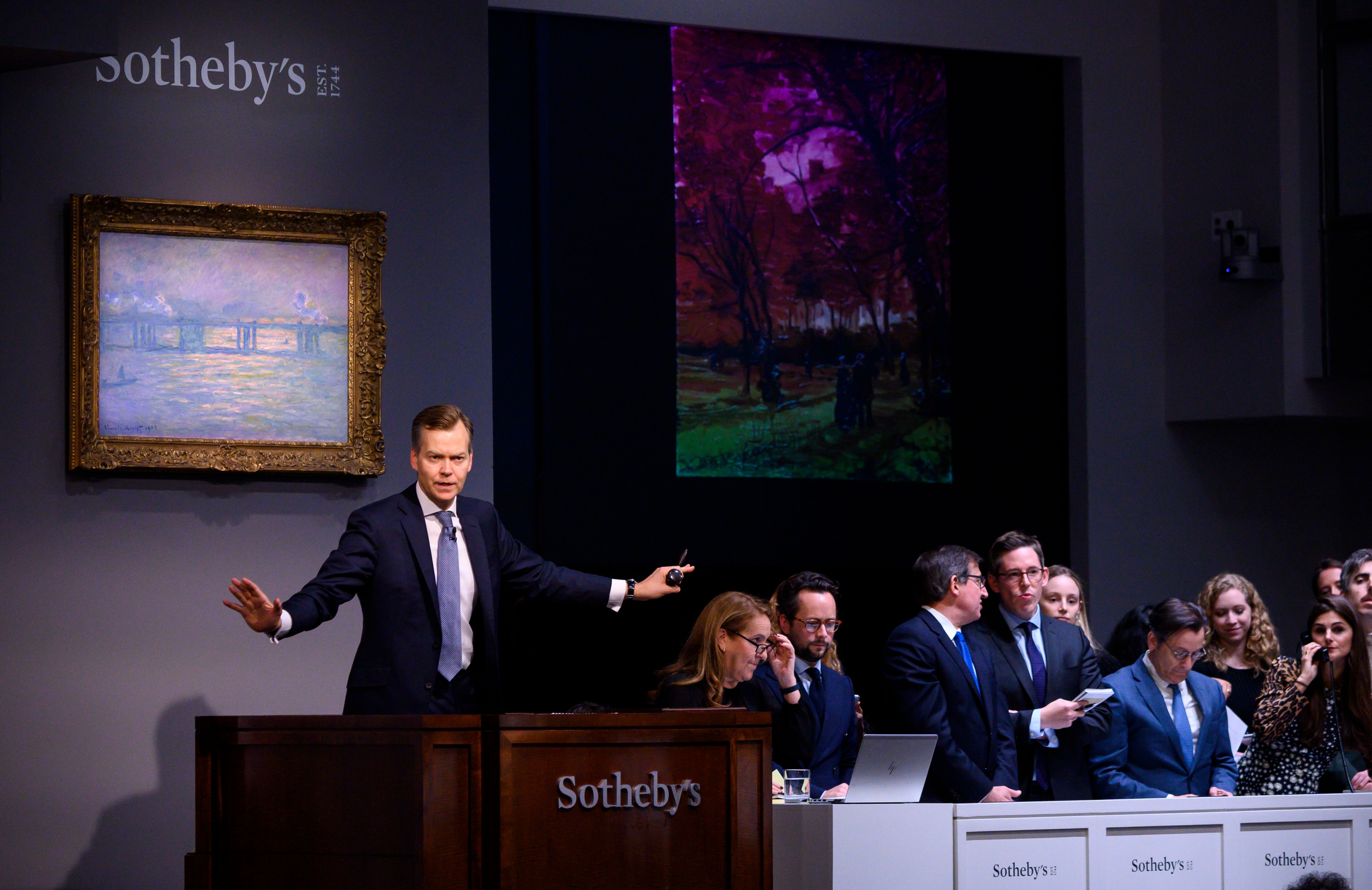 Sotheby's auctioneer Oliver Barker takes bids on Van Gogh's "People strolling in a Park in Paris."