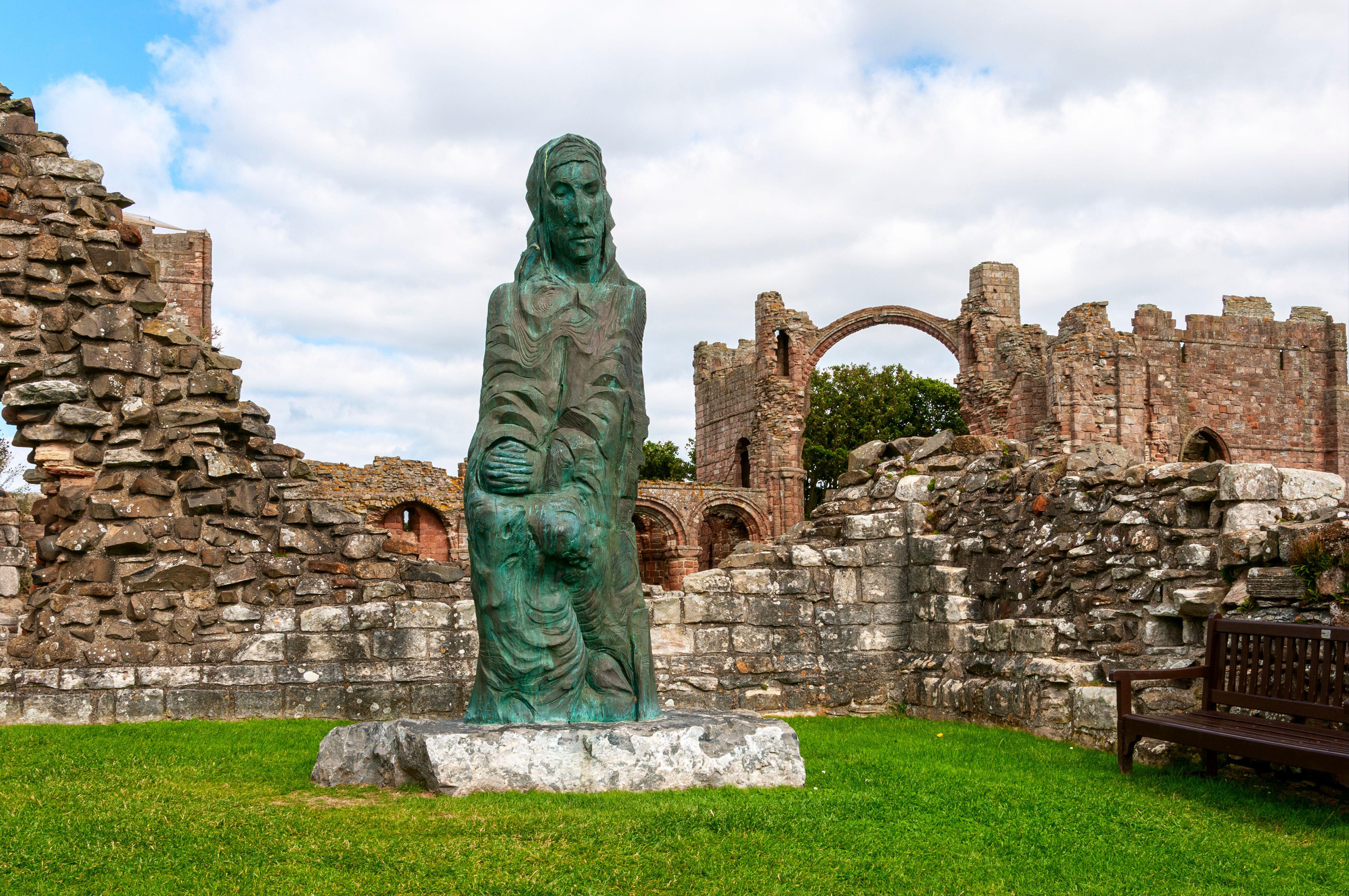 Bronze statue of St. Cuthbert by Fenwick Lawson at Lindisfarne Priory.