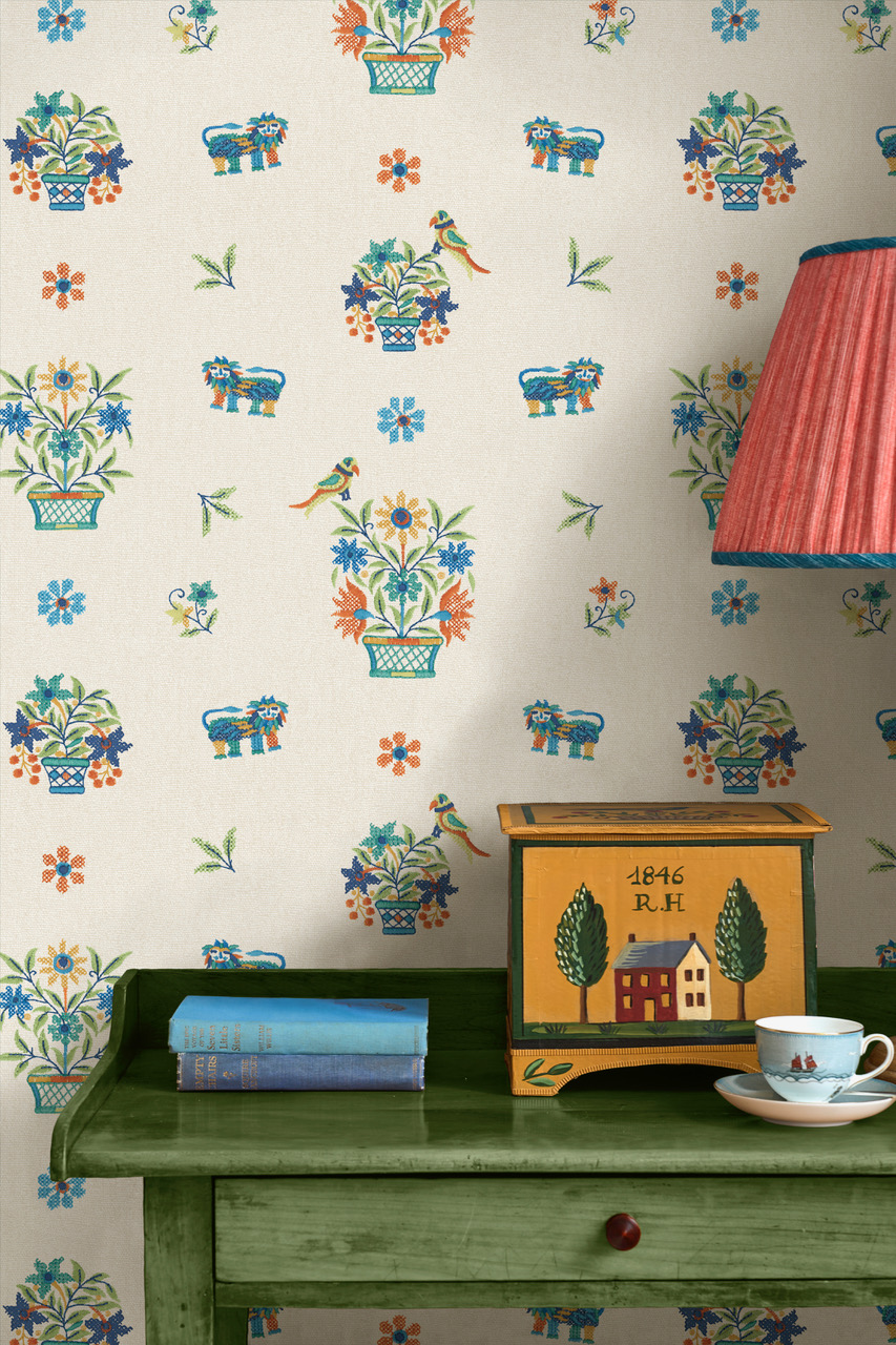 Illustration of Roar Stitch pattern wallpaper with a green table, painted box, and teacup.