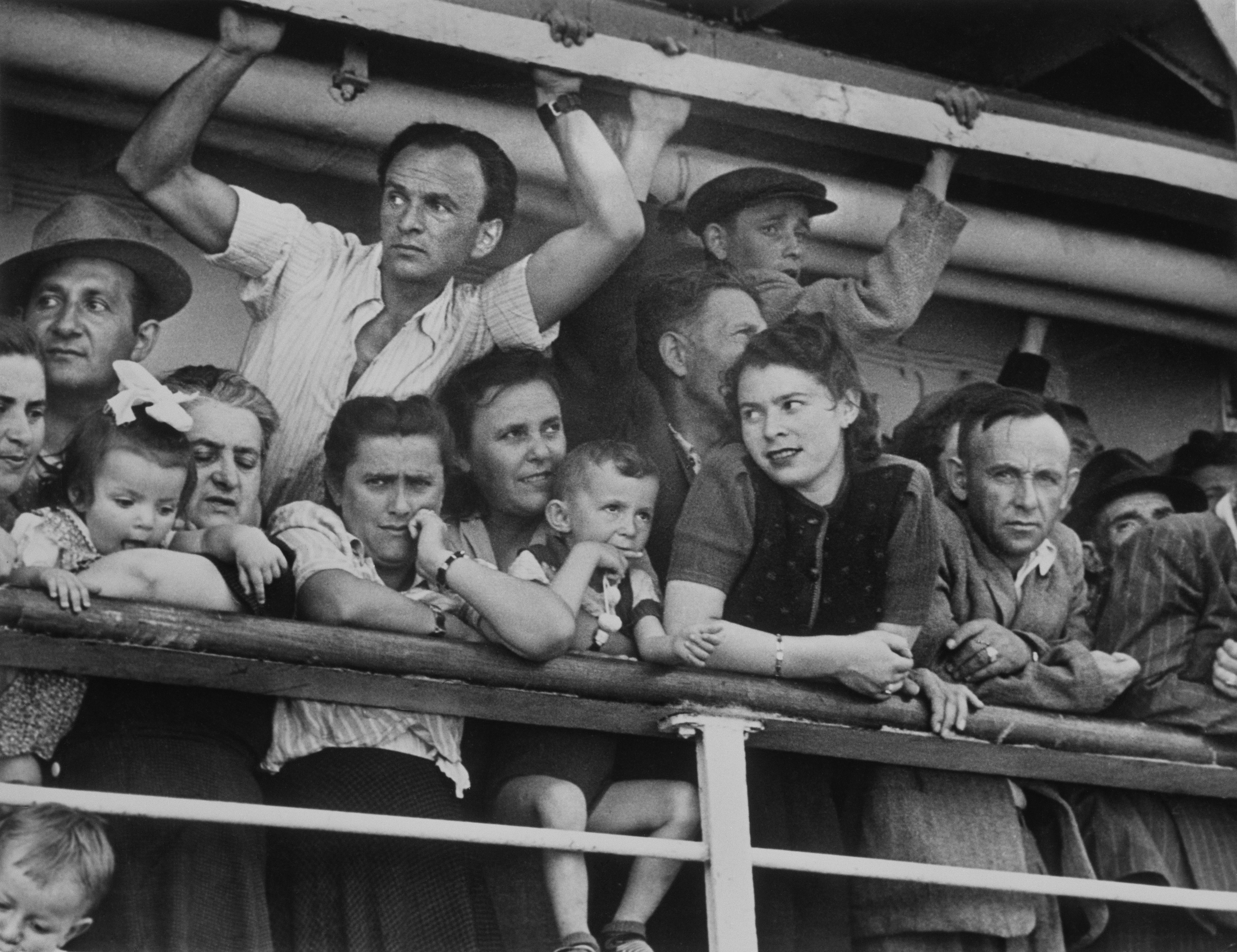 Immigrants from Eastern Europe, Turkey, and Tunisia looking out from a ship in Haifa, Israel, in 1949.