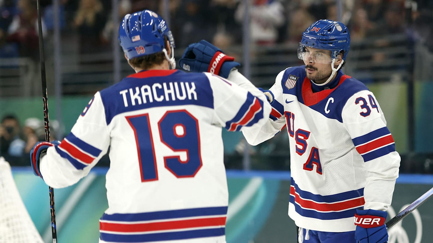 Feb 12, 2026; Milan, Italy;  Auston Matthews of United States celebrates scoring their fifth goal with Matthew Tkachuk of United States against Latvia in men's ice hockey group C play during the Milano Cortina 2026 Olympic Winter Games at Milano Santagiulia Ice Hockey Arena. Mandatory Credit: Geoff Burke-Imagn Images