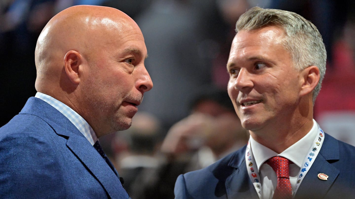 Jul 7, 2022; Montreal, Quebec, CANADA; Montreal Canadiens general manager Kent Hughes (left) talks with head coach Martin St. Louis before the first round of the 2022 NHL Draft at Bell Centre. Mandatory Credit: Eric Bolte-Imagn Images