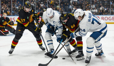 Jan 31, 2026; Vancouver, British Columbia, CAN; Vancouver Canucks defenseman Tyler Myers (57) and forward David Kampf (64) battle with Toronto Maple Leafs forward Auston Matthews (34) and forward Bobby McMann (74) in the third period at Rogers Arena. Mandatory Credit: Bob Frid-Imagn Images