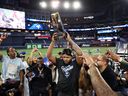 Vladimir Guerrero Jr. of the Toronto Blue Jays lifts the William Harridge Trophy after the Blue Jays defeated the Seattle Mariners in the American League Championship Series.