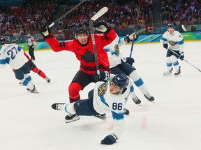 Macklin Celebrini of Team Canada and Teuvo Teravainen of Team Finland collide during during the Men's Semifinals Playoff match at the Milano Cortina 2026 Winter Olympic Games.