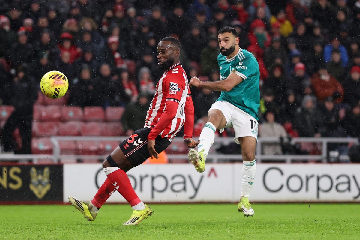 SUNDERLAND, ENGLAND - FEBRUARY 11: Mohamed Salah of Liverpool takes a shot whilst under pressure from Lutsharel Geertruida of Sunderland during the Premier League match between Sunderland and Liverpool at Stadium of Light on February 11, 2026 in Sunderland, England. (Photo by Stu Forster/Getty Images)