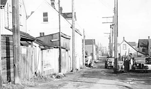 A black and white photo from the City of Vancouver Archives shows Hogan's Alley in 1958.