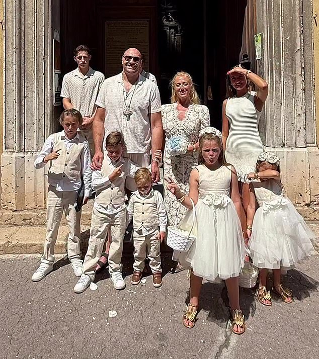 Fury is pictured with wife Paris and their large family. The couple have seven children