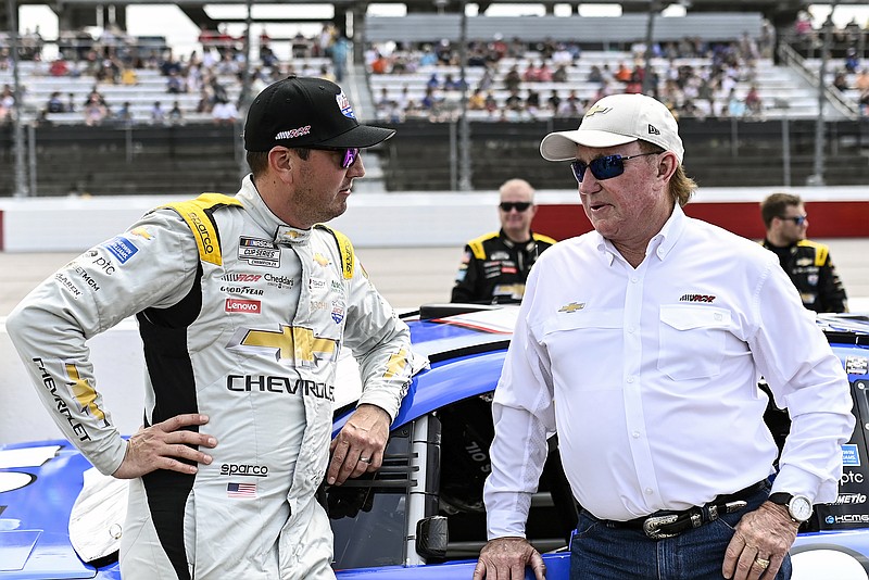 AP photo by Matt Kelley / NASCAR driver Kyle Busch, left, and team owner Richard Childress talk before a Cup Series race at South Carolina's Darlington Raceway on May 14, 2023. Busch won three times in the first 15 regular-season races that year, his first driving for Childress, but is currently mired in a 94-race losing streak in Cup Series competition.
