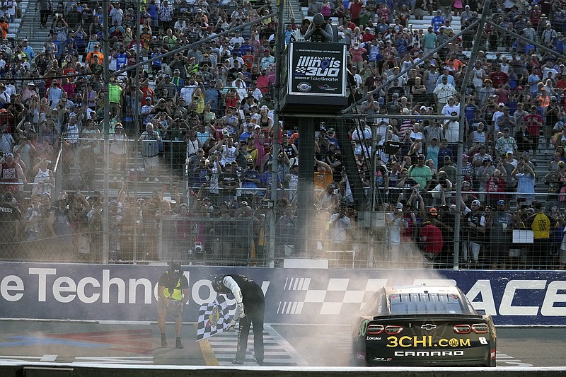 AP photo by Jeff Roberson / Kyle Busch bows to fans while holding the checkered flag as he celebrates after winning a NASCAR Cup Series race at World Wide Technology Raceway on June 4, 2023, in Madison, Ill. It was the 63rd win of his Cup Series career, but Busch has not been back to victory lane on NASCAR's highest level since then.