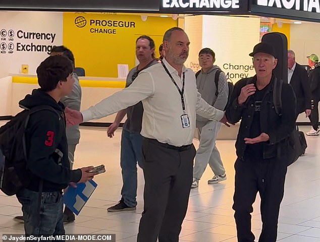 Officials needed to step in to separate McEnroe and the young fan as the situation threatened to escalate (pictured)