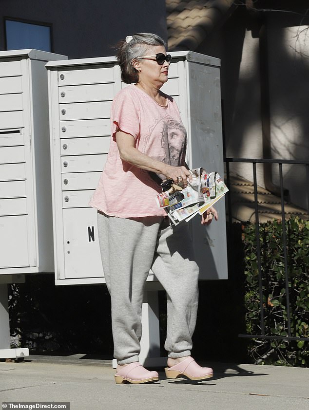 The 61-year-old actress cut a relaxed figure as she ran errands in Los Angeles on Tuesday, stepping out in a pink Jesus T-shirt, gray sweatpants and pink studded clogs to pick up her mail