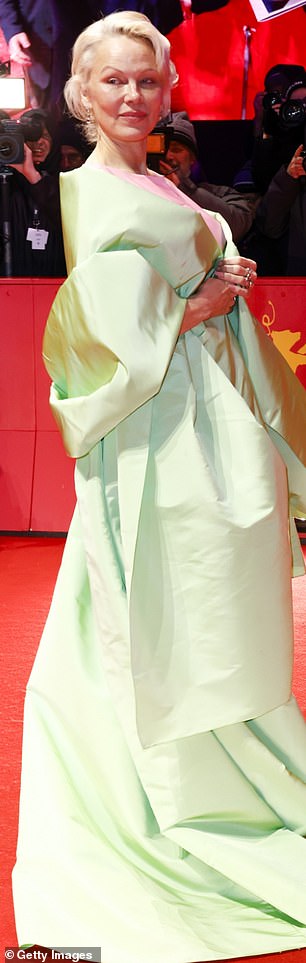 She wowed in a lime green and salmon pink dress complete with a matching shawl