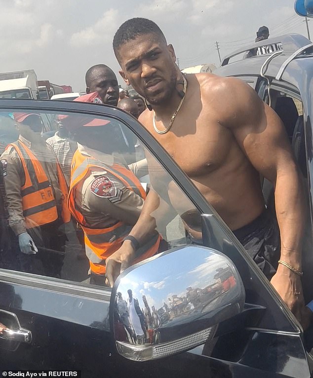 Anthony Joshua leaving the car after the crash which killed two of his friends in Nigeria