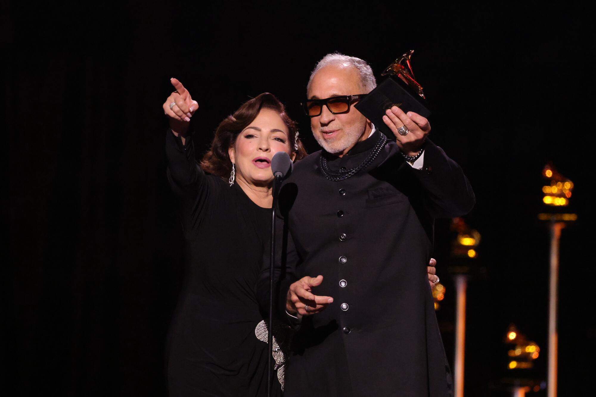 Gloria Estefan and Emilio Estefan accept a Grammy