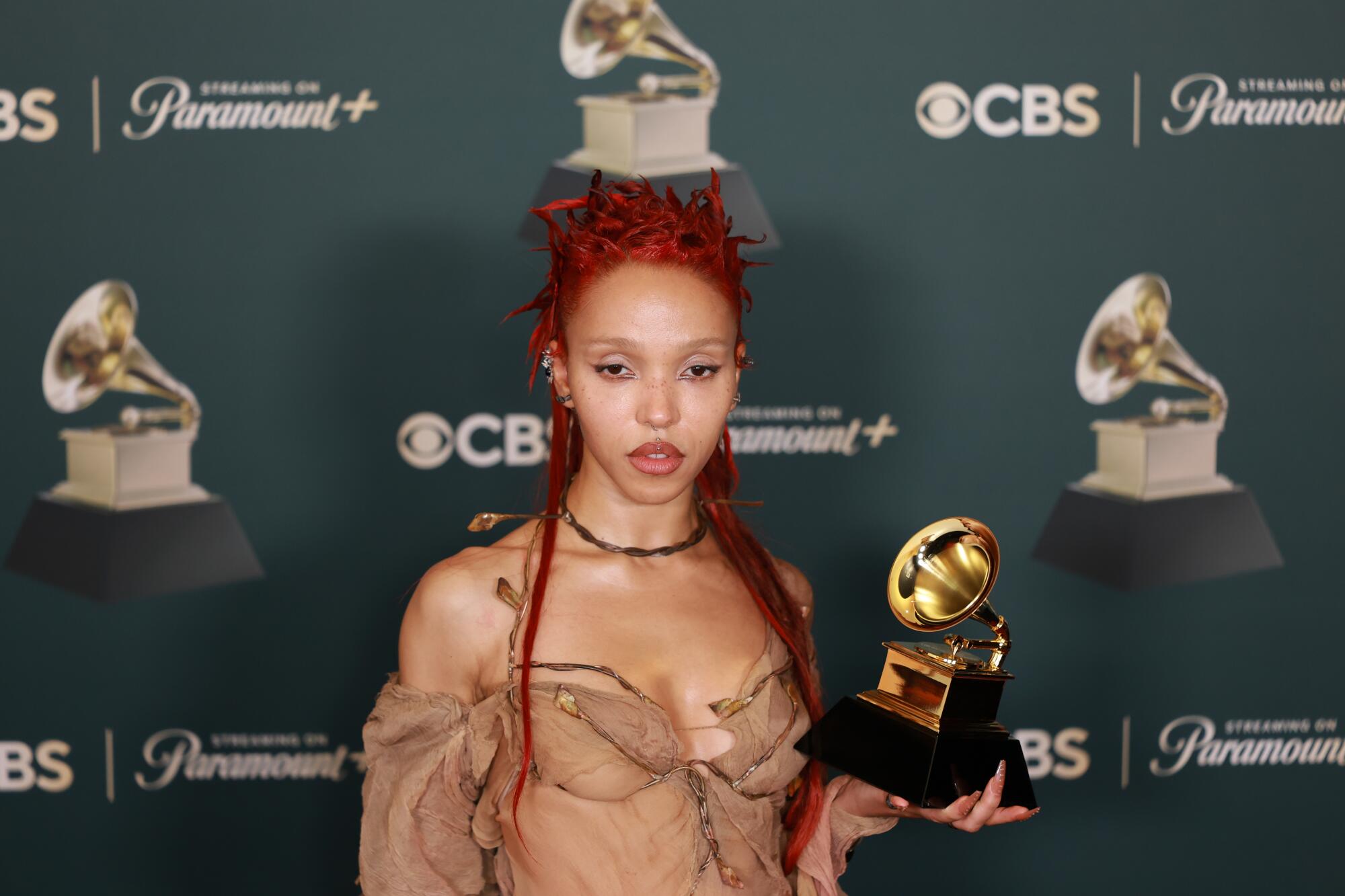 FKA twigs holds a Grammy.