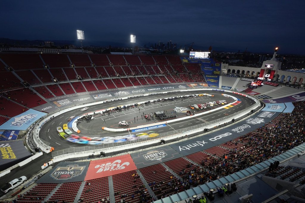 FILE - Cars race during the Busch Light Clash NASCAR exhibition auto race at Los Angeles Memorial Coliseum, Feb. 3, 2024, in Los Angeles. (AP Photo/Mark J. Terrill, File)
