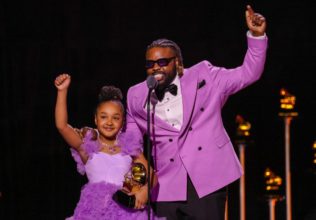 Aura V and Fyutch accept the Best Children's Music Album award for "Harmony" at the 2026 Grammy Awards.