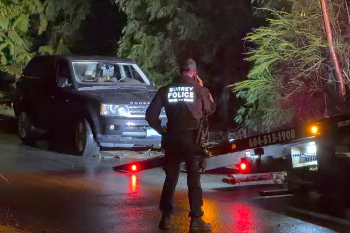 A black Range Rover is about to be wheeled onto a tow-truck-type vehicle.