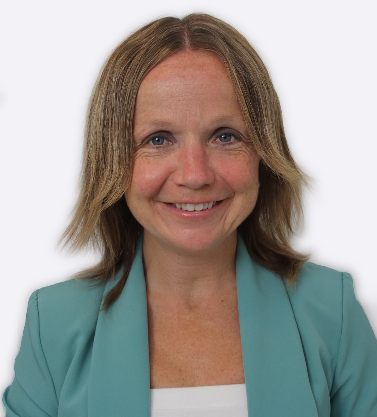 A close up of a smiling woman with blonde hair, wearing a blue blazer.