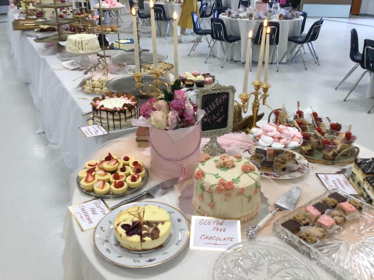 Tables filled with dozens of cakes and pastries and flowers.