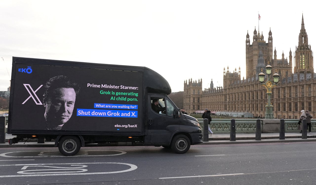 A truck with a digital billboard that reads "Prime Minister Starmer: Grok is generating AI child porn. What are you waiting for? Shut down Grok and X." drives past U.K. houses of Parliament. 