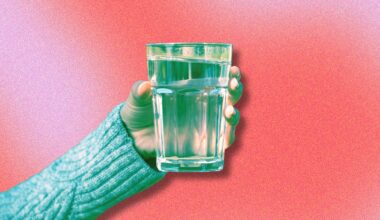 person holding a glass of water