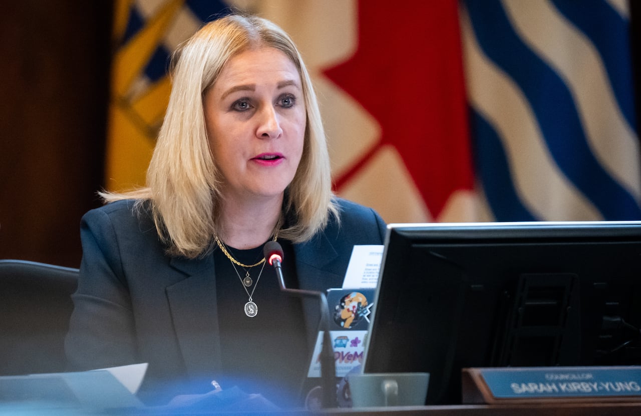 A blond woman is seen in council chambers.