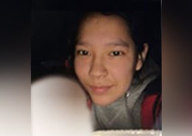 A woman wearing a sweater is seen in a picture.