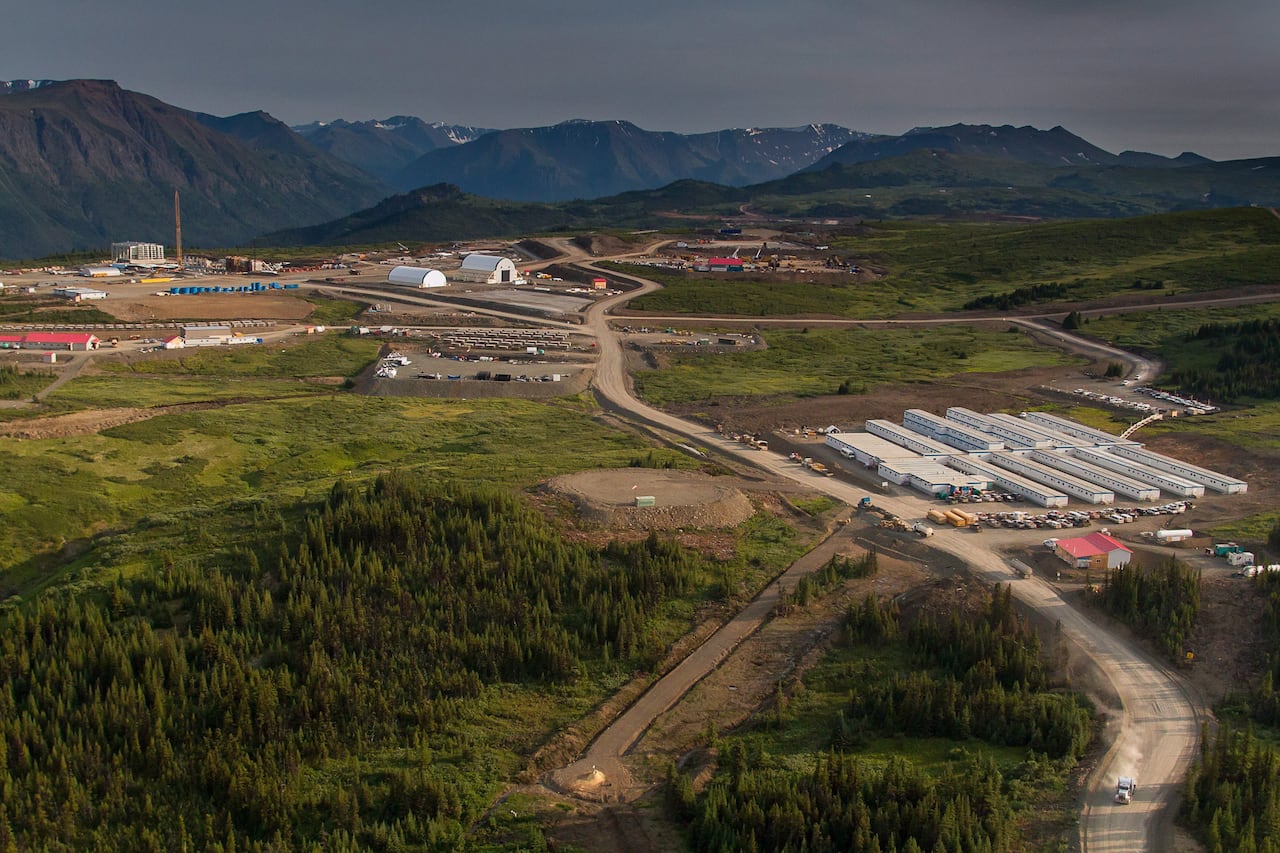 An overhead picture of a mine site surrounded by lush green trees.