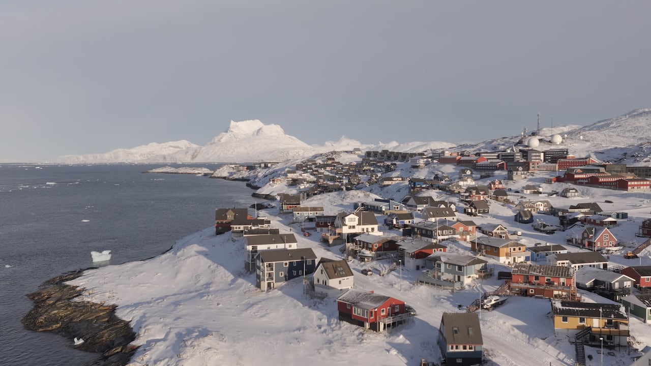 An aerial shot of buildings on a snowy island.