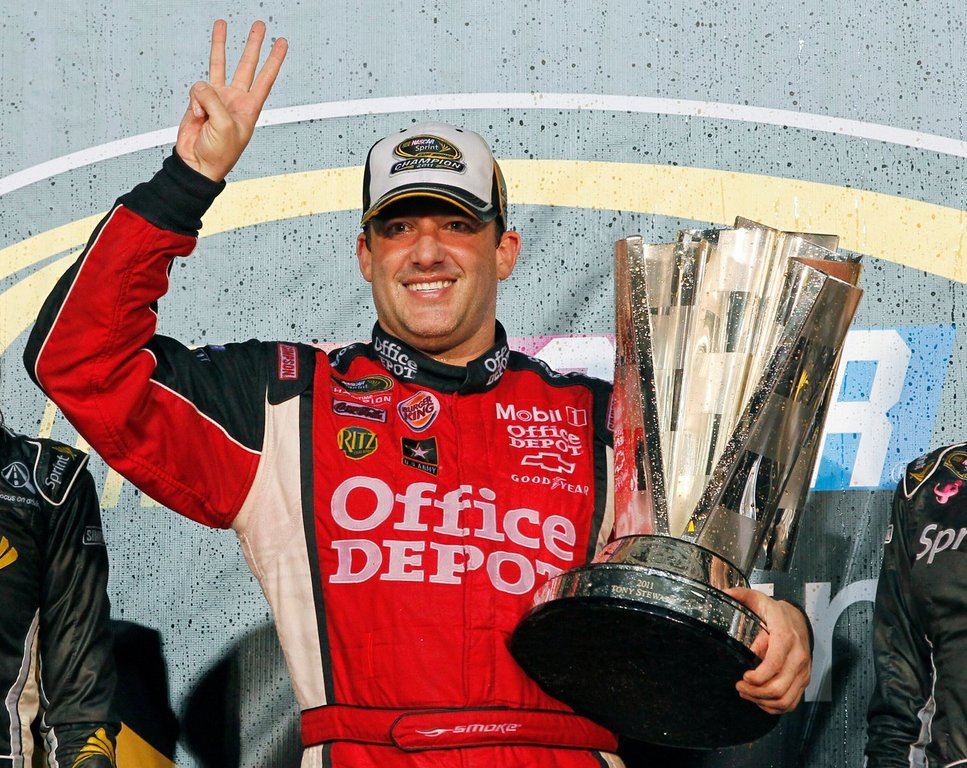 FILE - In this Nov. 20, 2011 file photo, Tony Stewart celebrates after winning his third NASCAR Sprint Cup Series championship, at Homestead-Miami Speedway in Homestead, Fla. (AP Photo/Terry Renna, File)