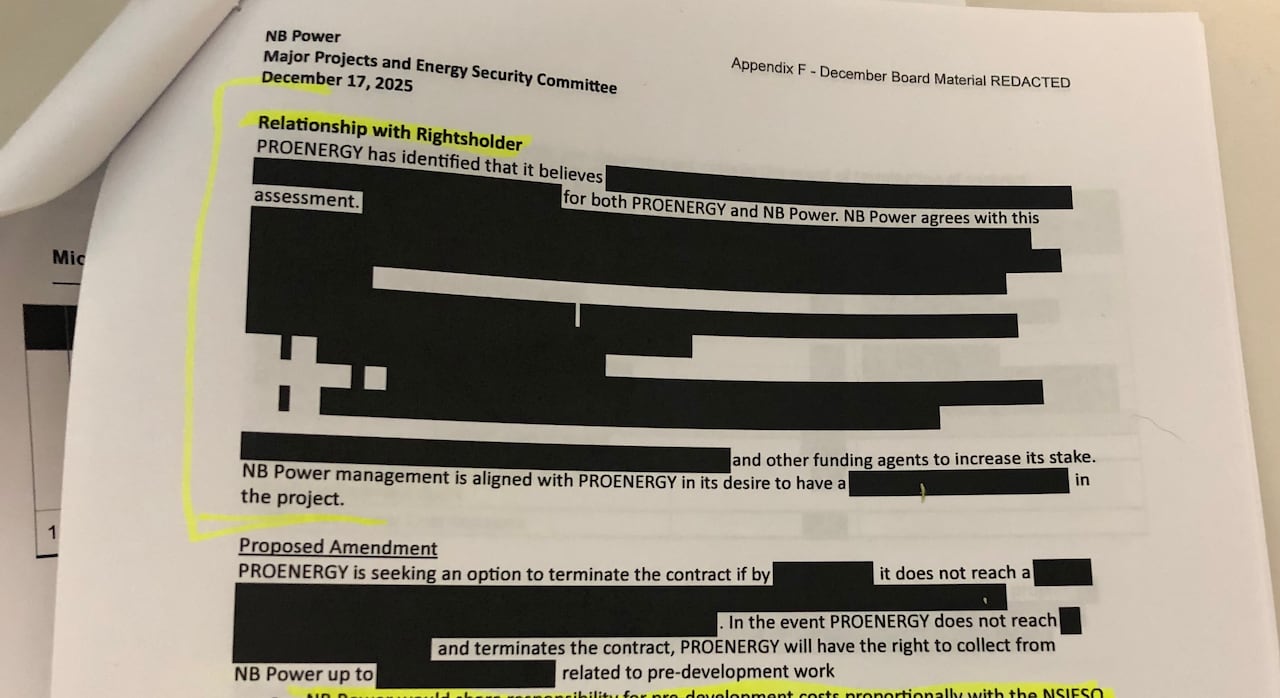 An NB Power document open to a page with text mostly blacked out, and some hand drawn highlighting marks on parts of text. 