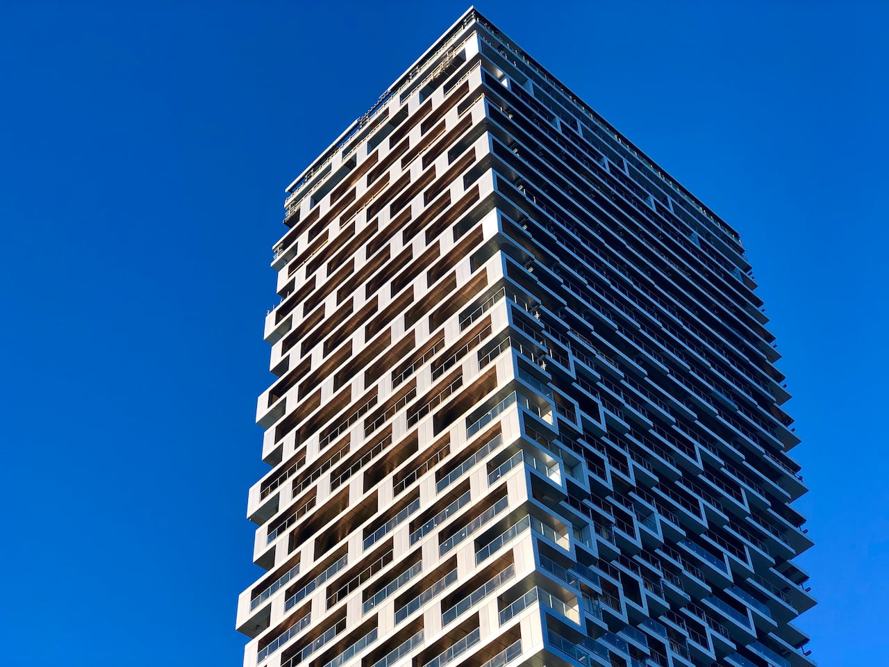 A condo building on a sunny day.