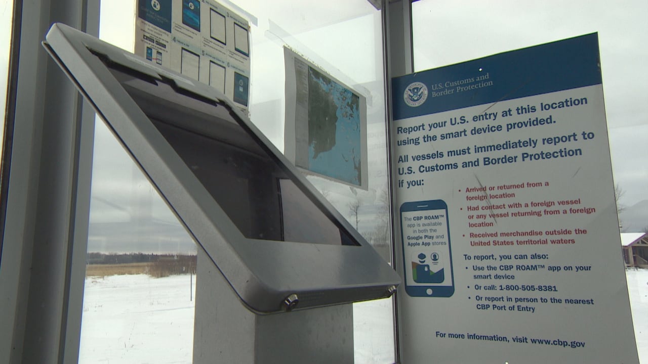 tablet and sign with instructions on how to check in with U.S. Customs and Border Protection