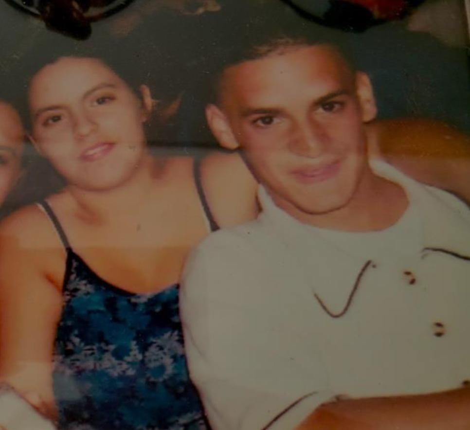 A young woman and young man together, smiling