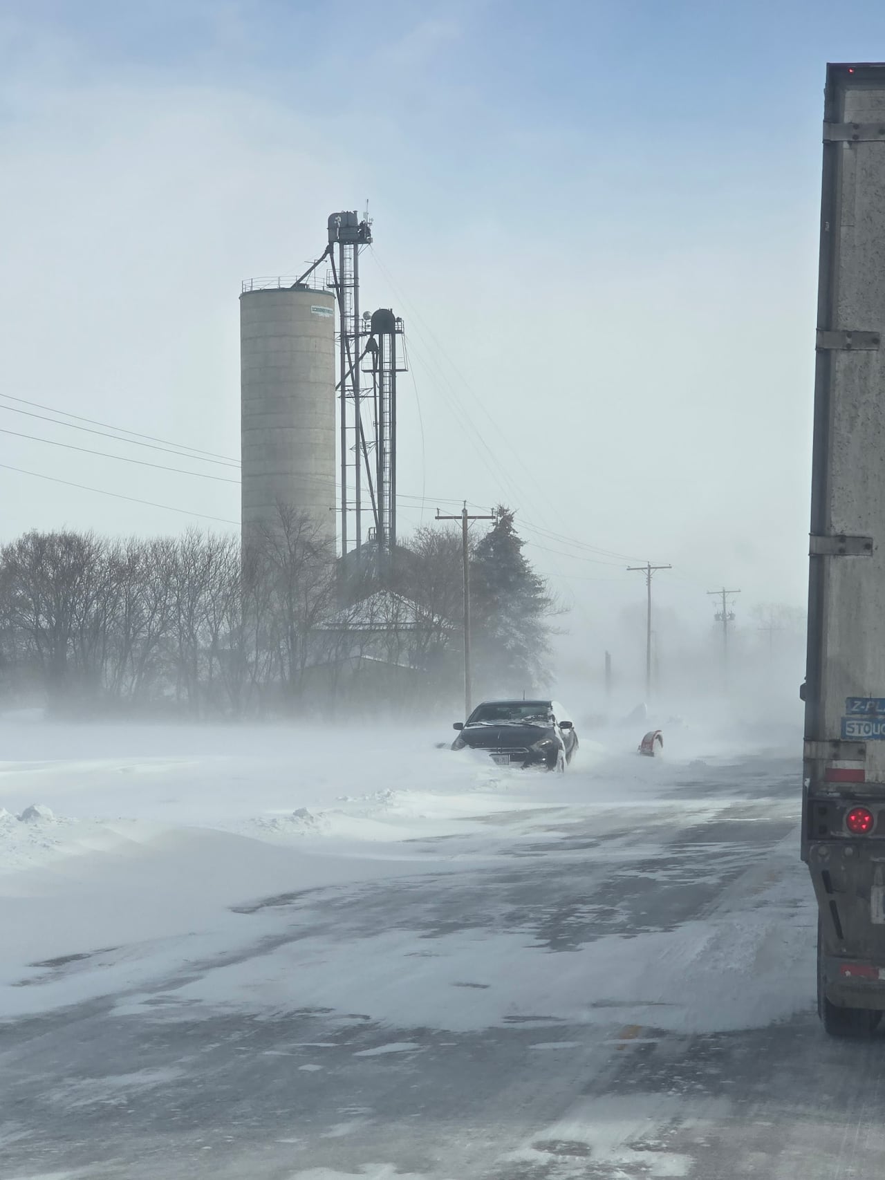 Many passenger vehicles were partially buried by snow.