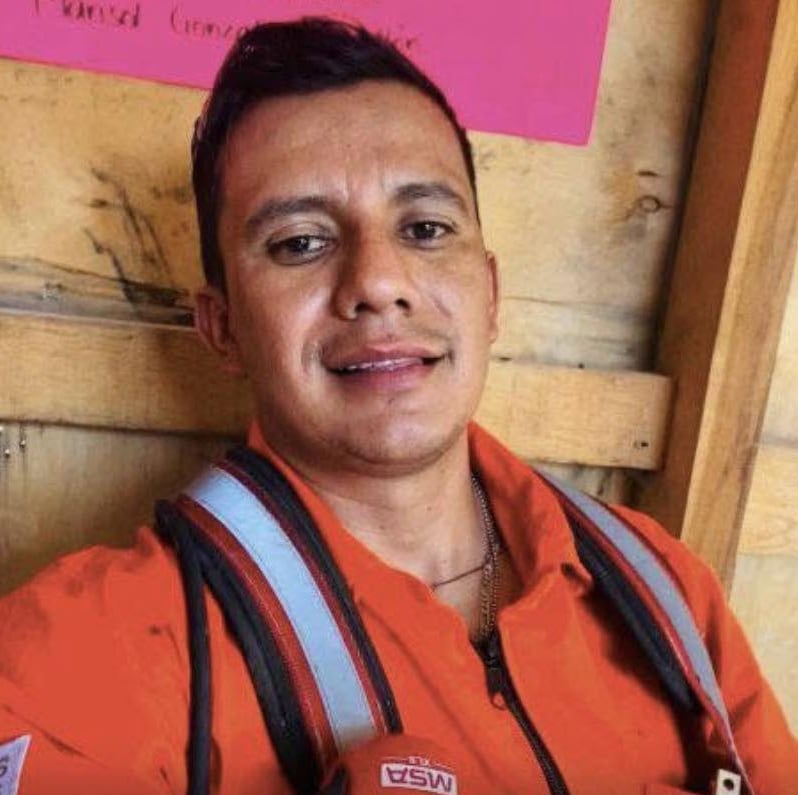 A young man in organge work clothes