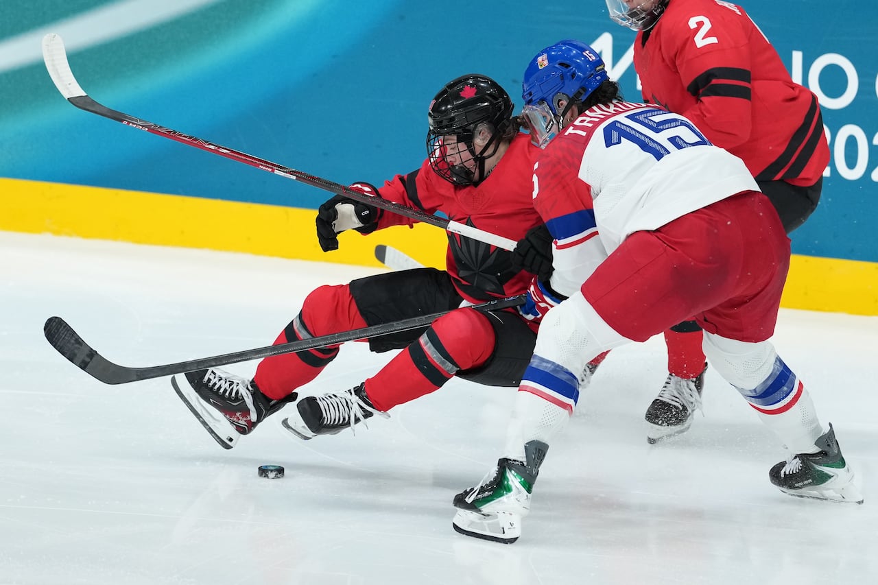 Two hockey players collide on the ice.