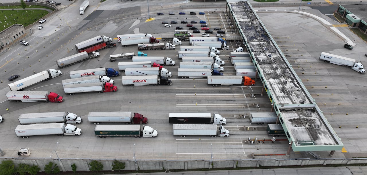 An aerial view of trucks lined up at a border crossing