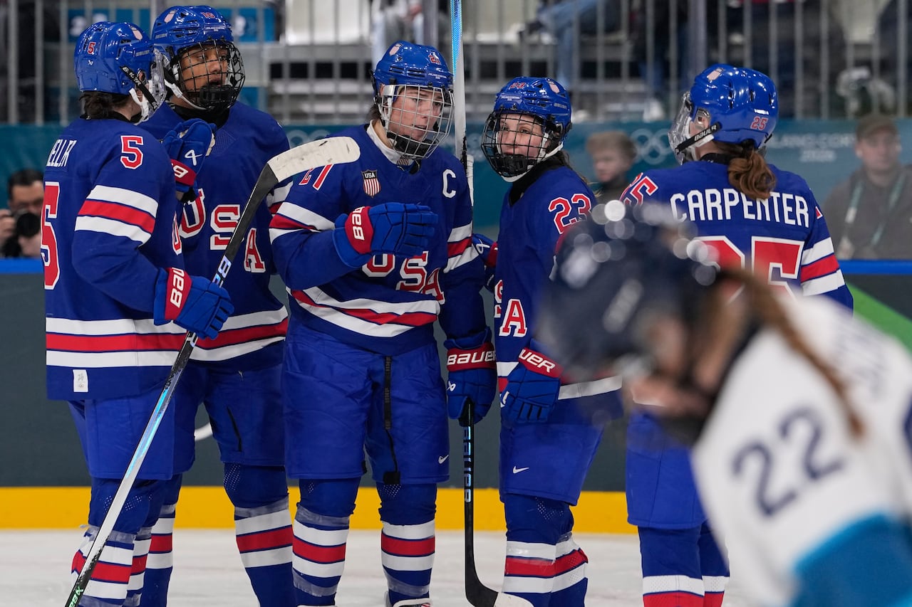 American hockey players talk to each other on the ice.