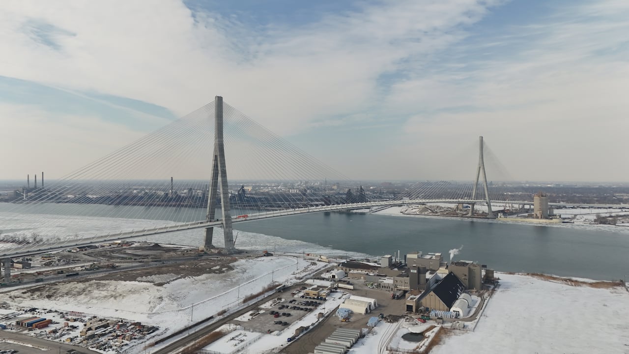 An aerial shot of a bridge in the wintertime.