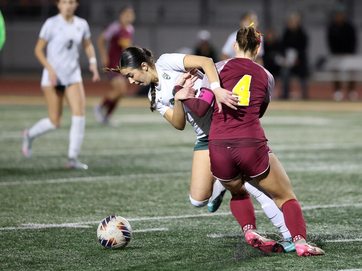 Estancia's Jana Akins (4) tries to control a dribble from South Hills' Jazelle Touzard (22) during Thursday's match.