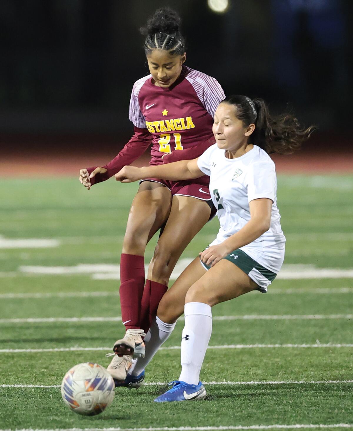 Estancia's Aisleen Avalos (21) moves ball upfield into a scoring position past South Hills' Michelle Garcia (2) on Thursday.