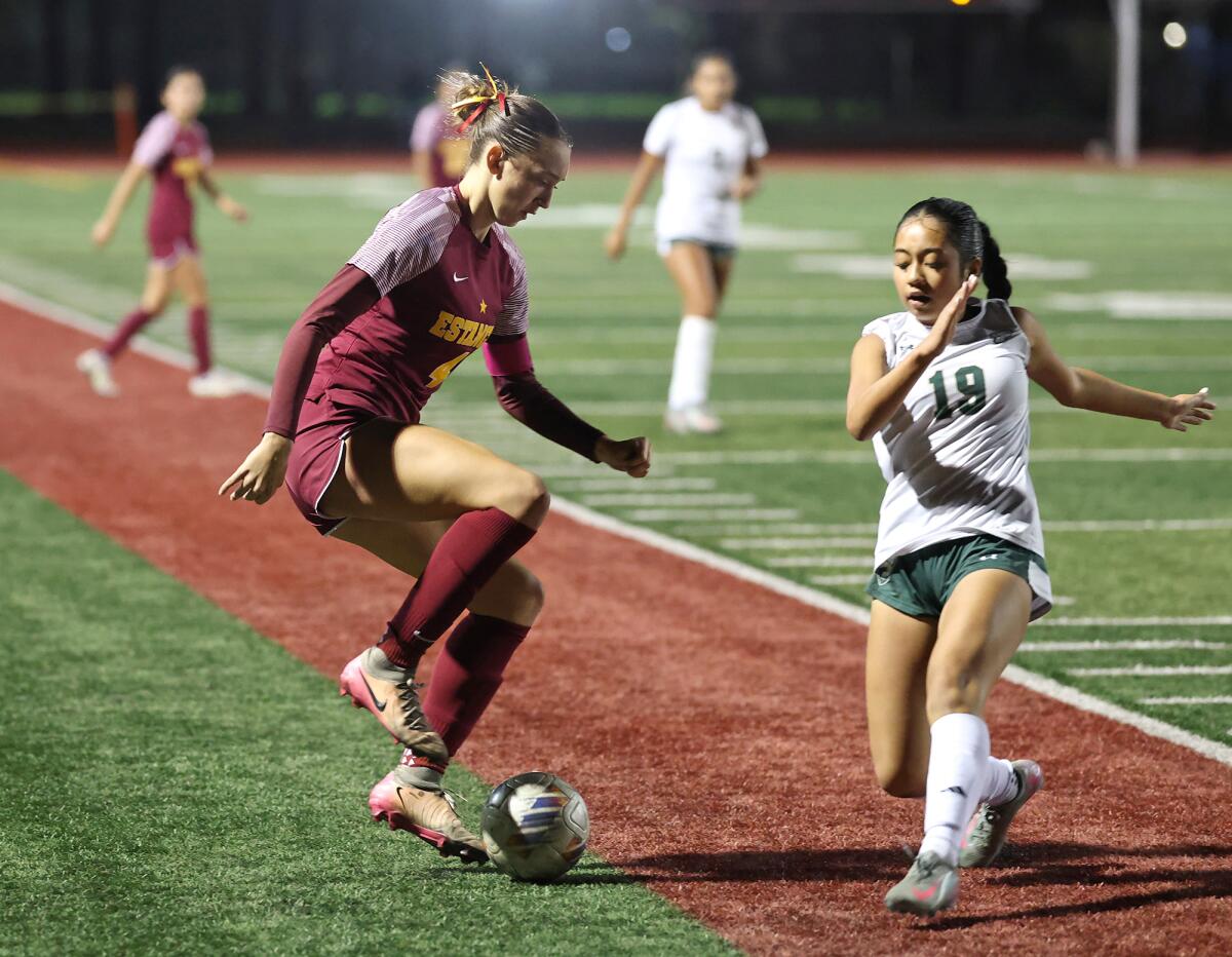 Estancia's Jana Akins (4) makes a move with the ball to secure possession against South Hills on Thursday.