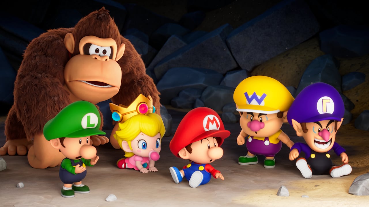 video game screenshot of mario, luigi and other nintendo characters as babies, next to a large adult Donkey Kong.